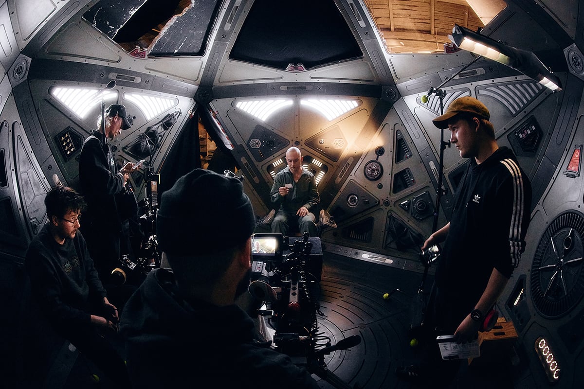 Film crew at work inside the spacecraft set featuring DMG Lighting.