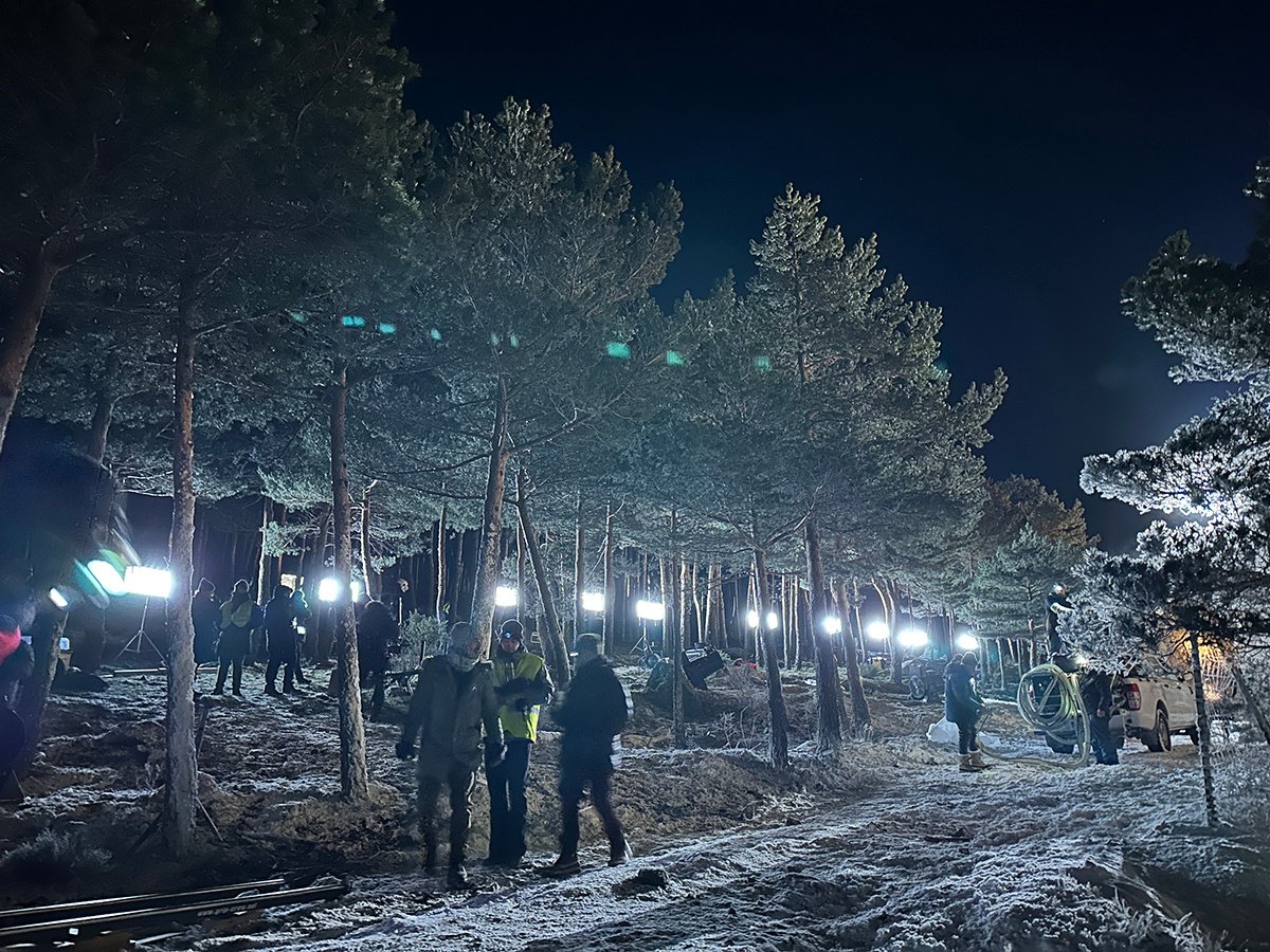 Forty DMG MAXI lighting fixtures illuminate a snow-covered road at night.