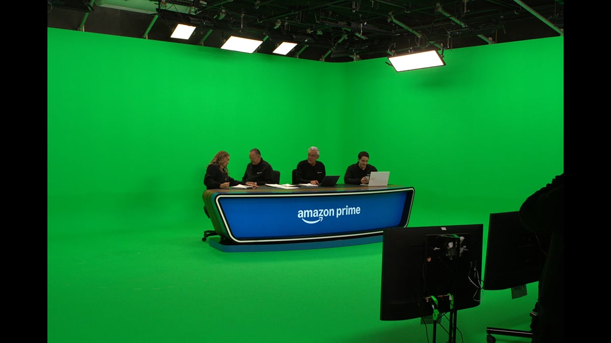Presenters inside Quanta’s virtual broadcast studio, featuring Rosco DigiComp HD paint. 