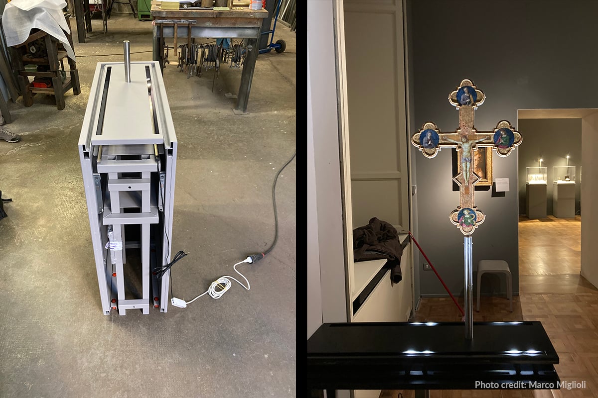 Display case under construction with eight integrated luminaires positioned to illuminate the Cross from all sides.