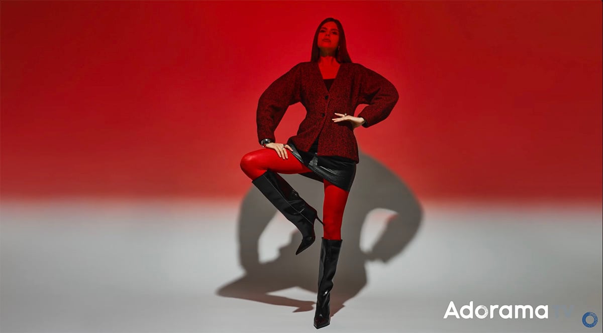 Rosco R26 Light Red gel bathing the model and background in a vivid red hue, creating bold, high-fashion editorial lighting.