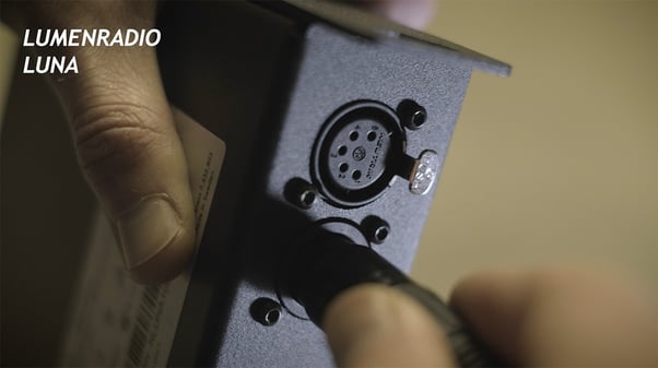Plugging a wireless DMX transceiver into the Dragonframe DDMX-512 box.