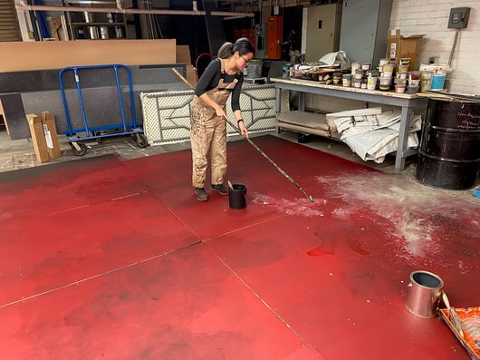 Rosco Supersaturated paints are used to recreate a red concrete surface marked by stains and imperfections for the Uncle Vanya set design.