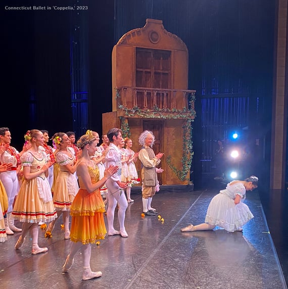 Ballet dancers on stage featuring a set painted with Off Broadway paint.