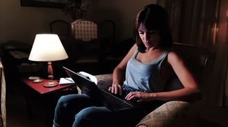 DMG DASH fixed onto a computer screen illuminates Actress Adriana Ugarte’s face