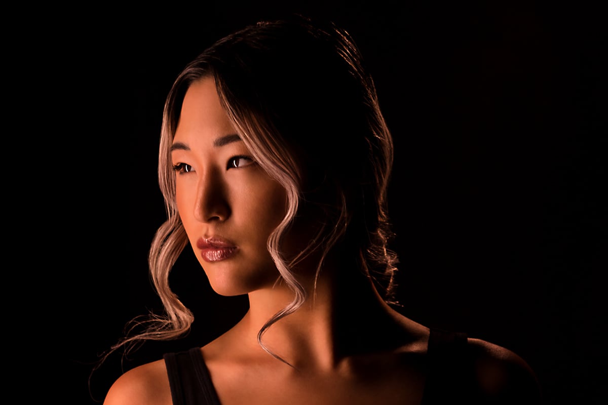 Face closeup of an Asian woman lit with DMG Lighting.