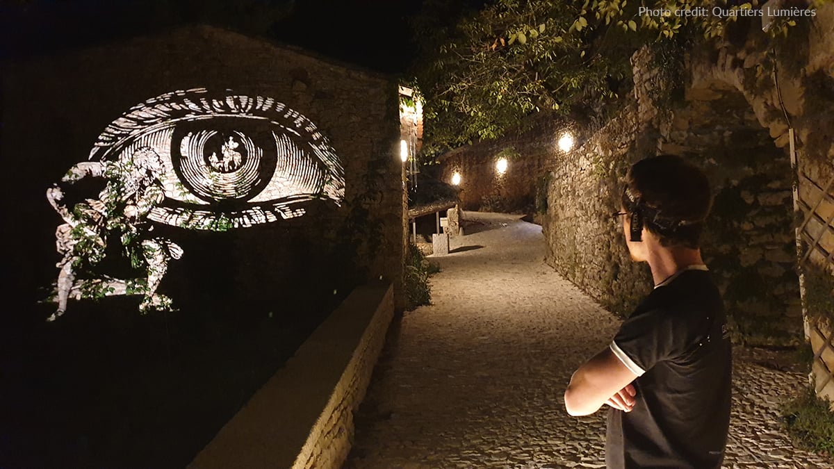 A visitor contemplates an image projected onto the wall by Image Spot gobo projector.