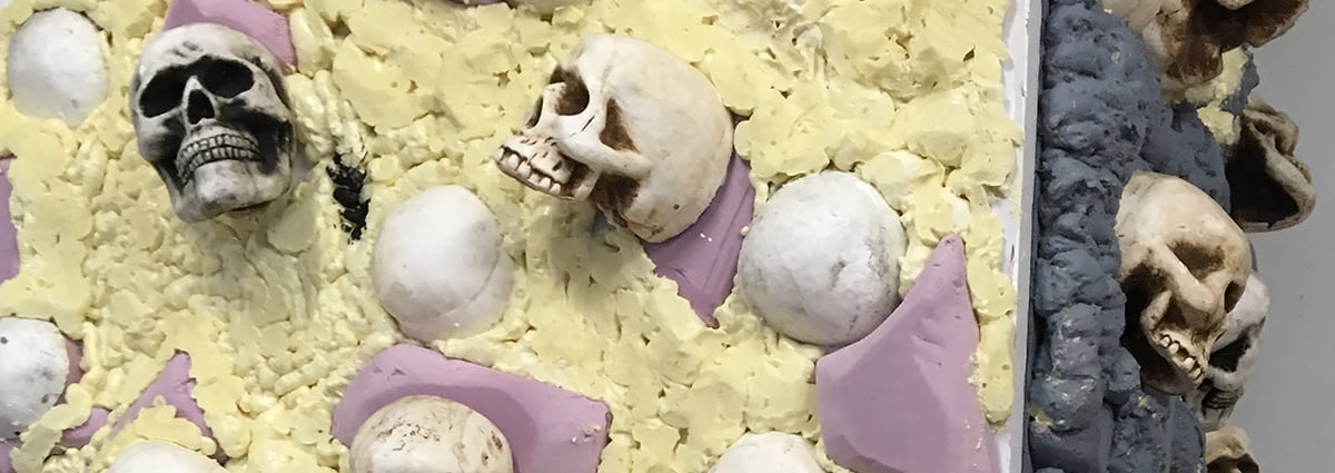 Prep for durable Halloween scenery using insulation foam carved to look like rocks and pre-painted skulls.