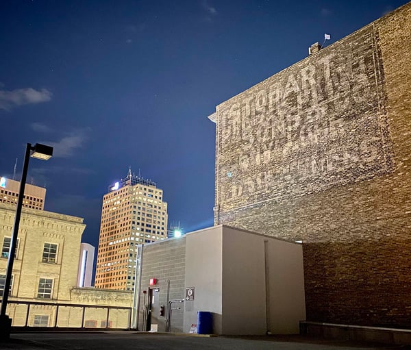 Three faded "ghost signs" can be seen on Winnipeg's historic Stobart building.