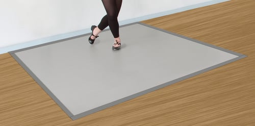 A dancer practices tap dancing on a Rosco Marley Mat at home.