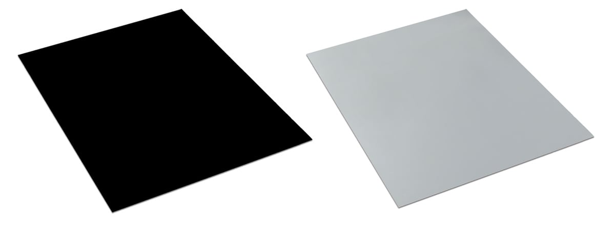 Product shot of a piece of Rosco Adagio Floor in black and a piece of Rosco Adagio Floor in Grey. 