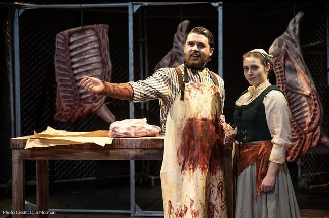 Realistic foam props, including life-sized slabs of beef and juicy steaks - all made using Rosco scenic paint and coatings products - on stage with two actors.