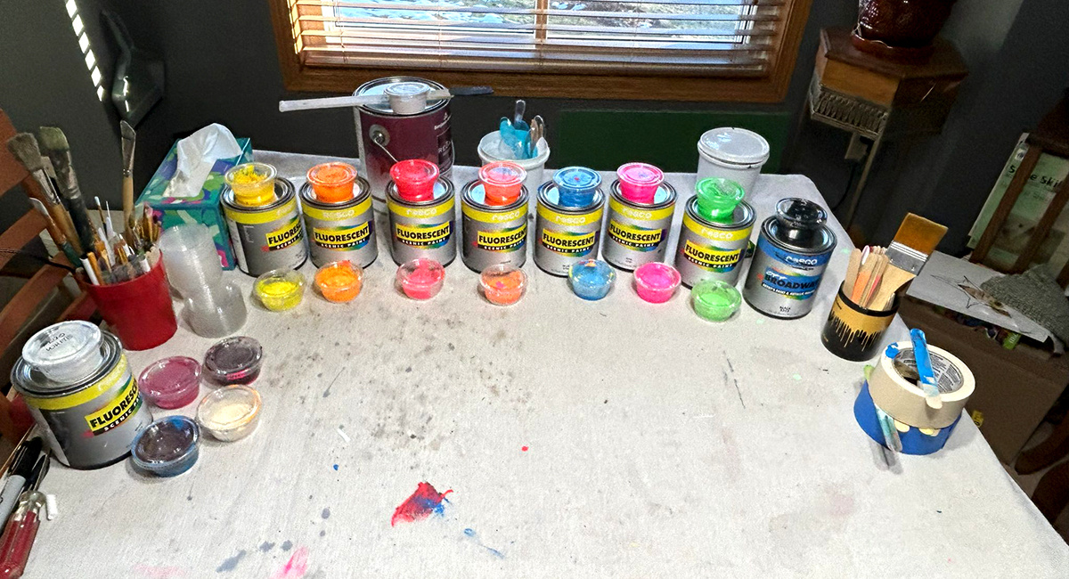 Rosco Fluorescent Paint cans and color sample containers.