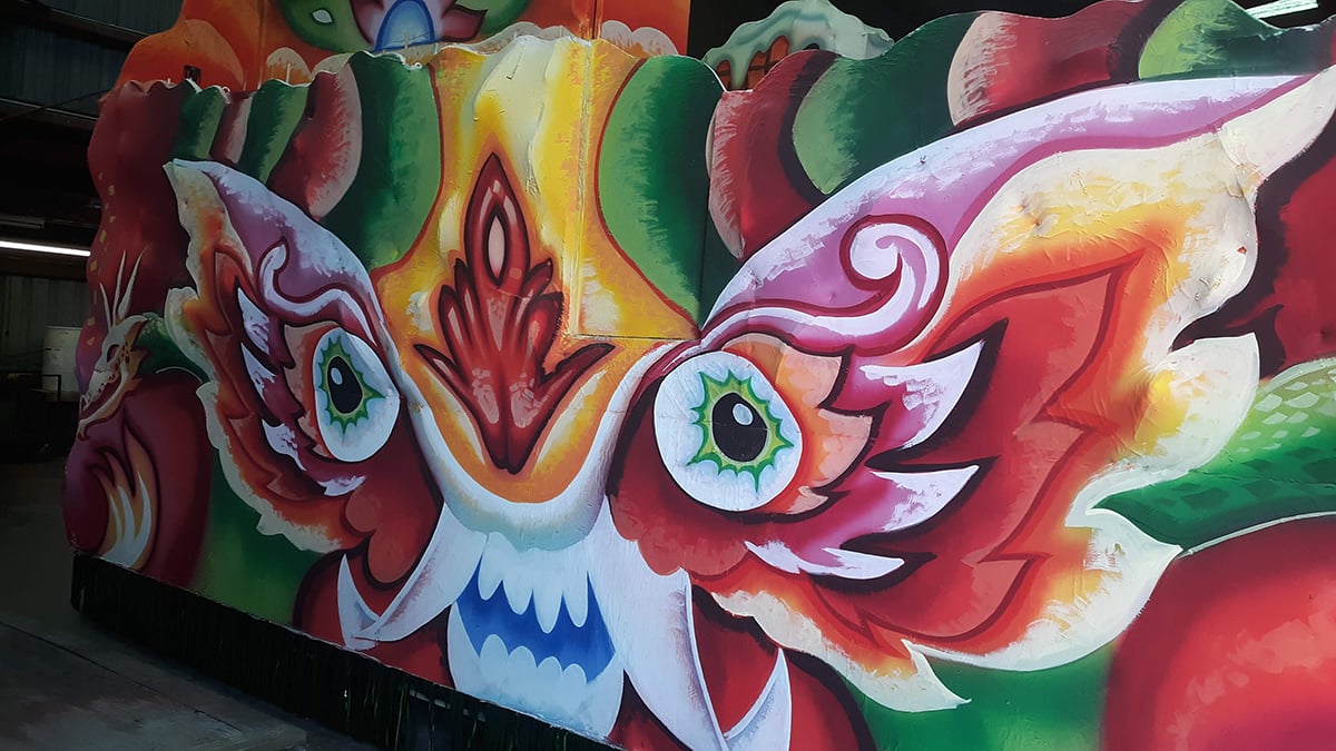 A colourful Mardi Gras float decorated with bold, detailed artwork painted using Rosco Off Broadway paint.