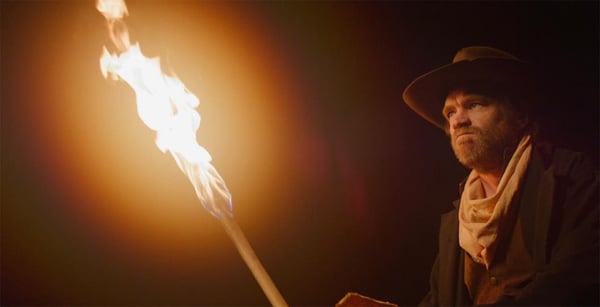 An actor is lit by several DMG Lighting fixtures to mimic the torchlight in this scene from horror western film, The Vast Lonesome.