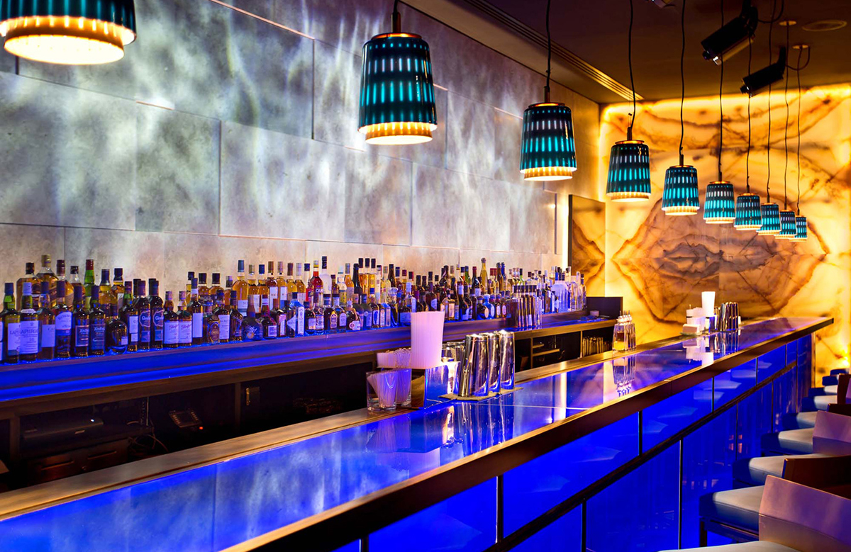 Dynamic water effect projected behind a restaurant bar with Rosco X-Effects