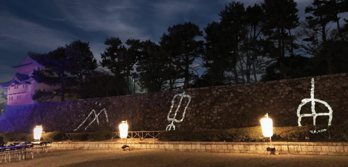 Kokumon gobo projections on the stone wall of Nagoya castle demonstrate a fusion of ancient tradition and lighting technology.