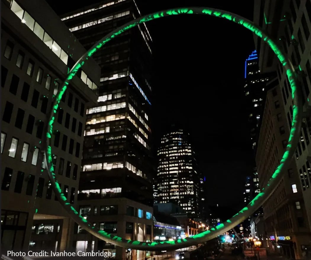 Patterned green light on the interior of the 90-ft L'Anneau ring